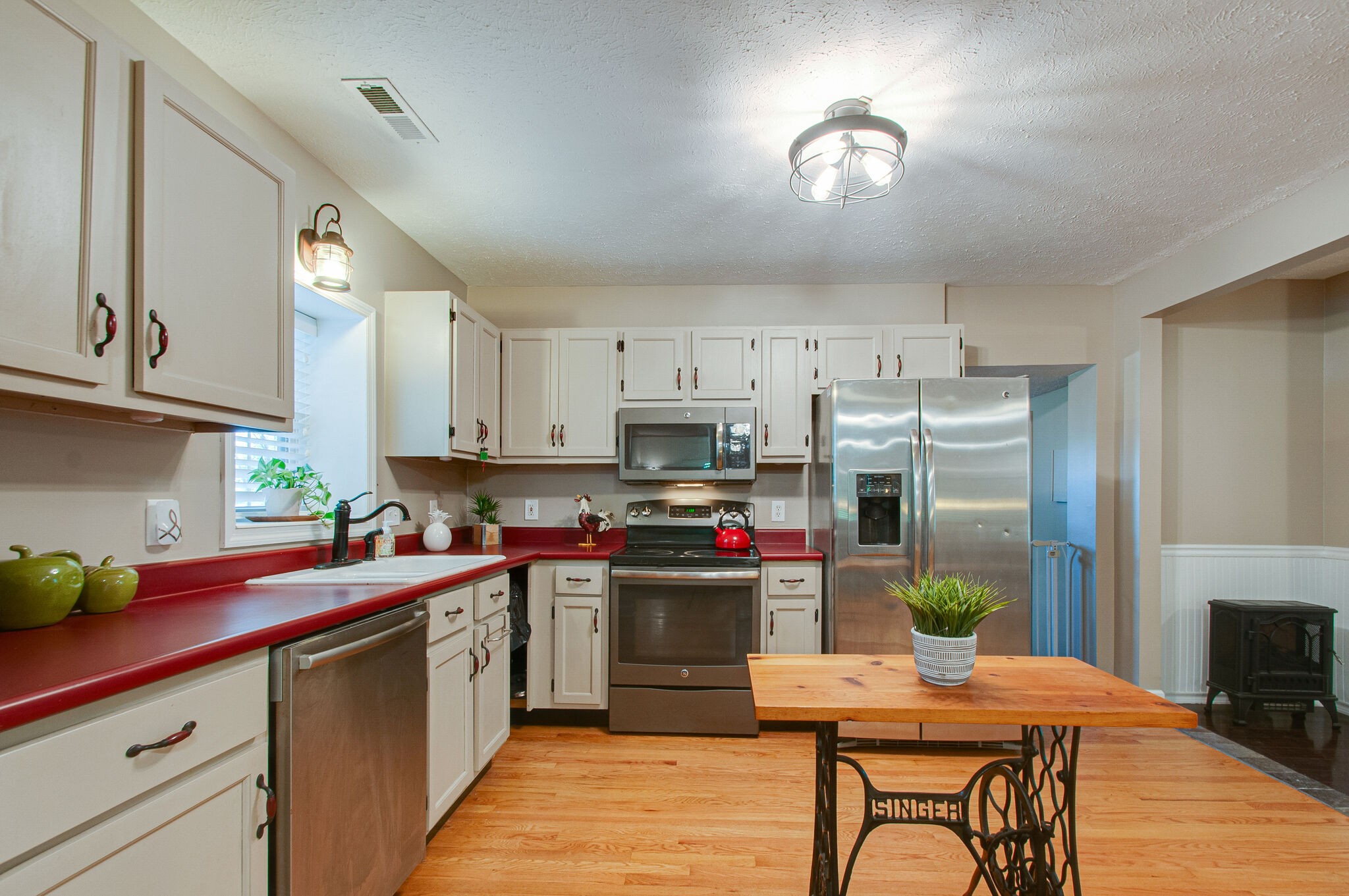 7264 Deer Ridge Road Fairview, TN 37062 - Photo 16 of 37 a kitchen with stainless steel appliances a stove refrigerator sink cabinets dining table and chairs