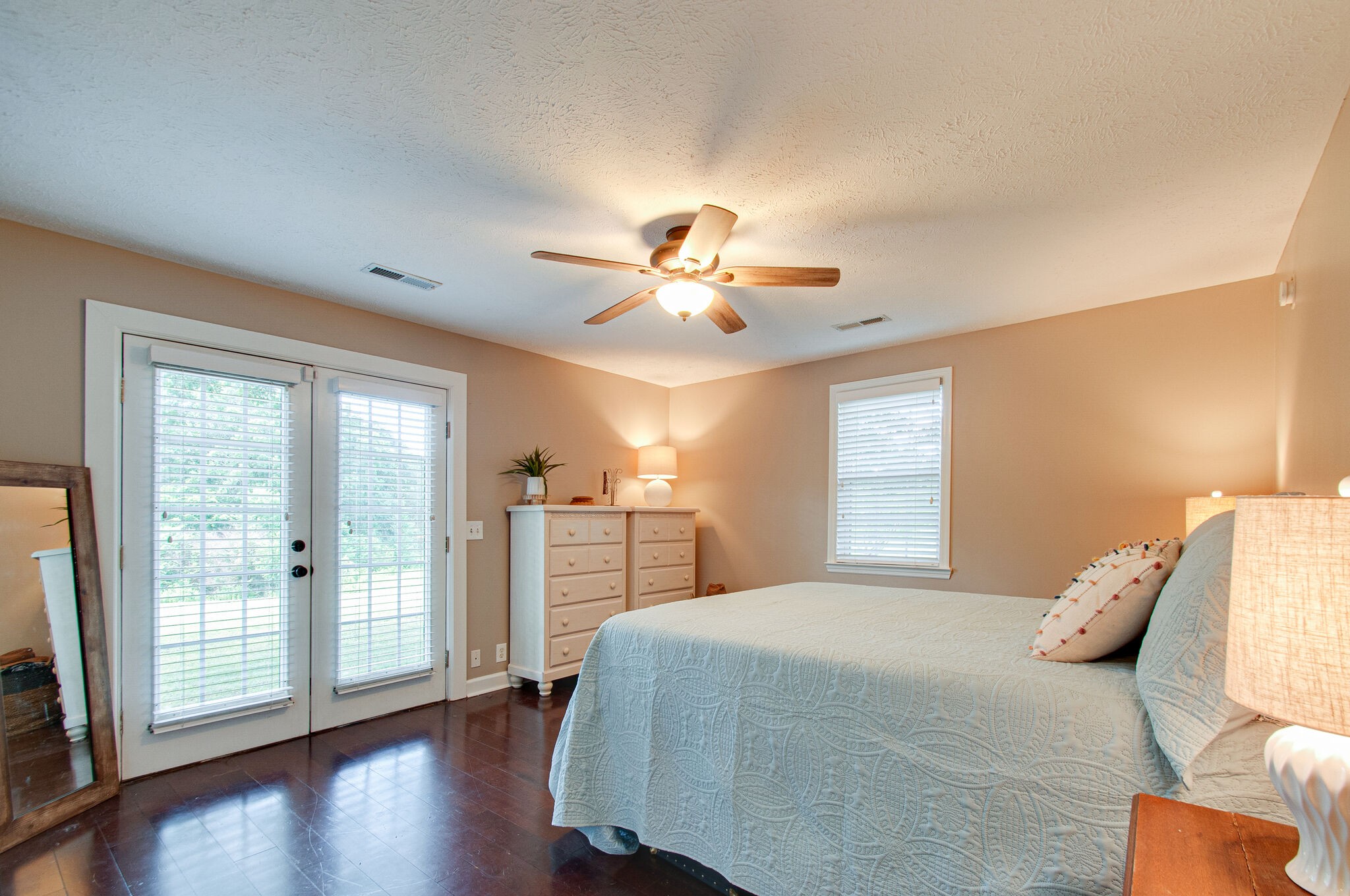 7264 Deer Ridge Road Fairview, TN 37062 - Photo 18 of 37 a bedroom with a large bed and a chandelier