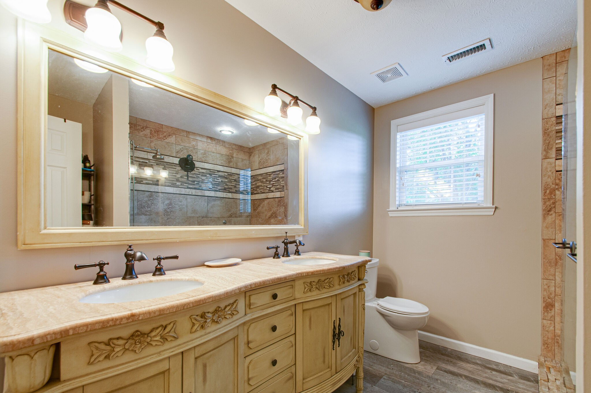 7264 Deer Ridge Road Fairview, TN 37062 - Photo 20 of 37 a bathroom with a granite countertop sink mirror vanity and toilet
