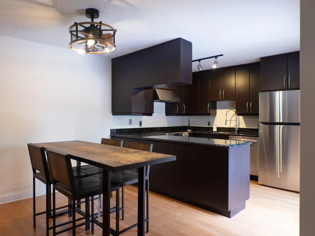 a kitchen with stainless steel appliances a sink stove and refrigerator