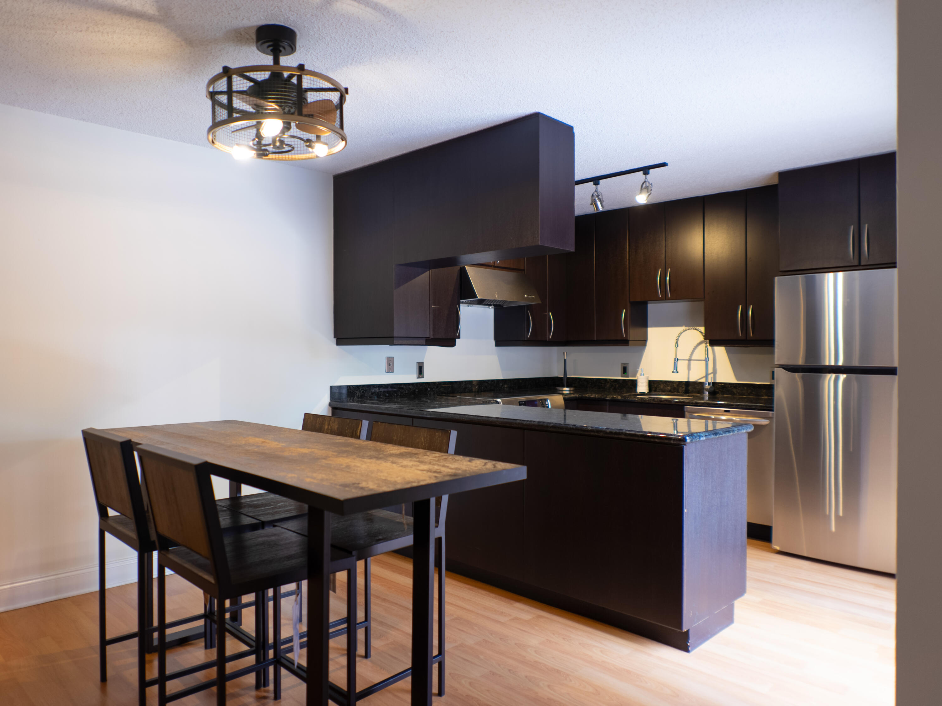 3118 Spanish Wells Drive, Unit 15B Delray Beach, FL 33445 - Photo 1 of 23 a kitchen with stainless steel appliances a sink stove and refrigerator
