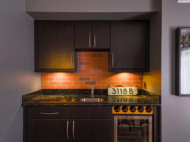 a kitchen with stainless steel appliances a stove and a microwave