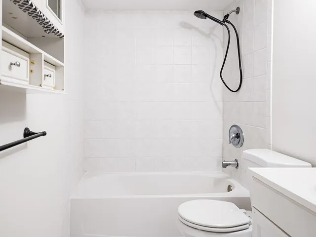 a bathroom with a sink a toilet and a bath tub