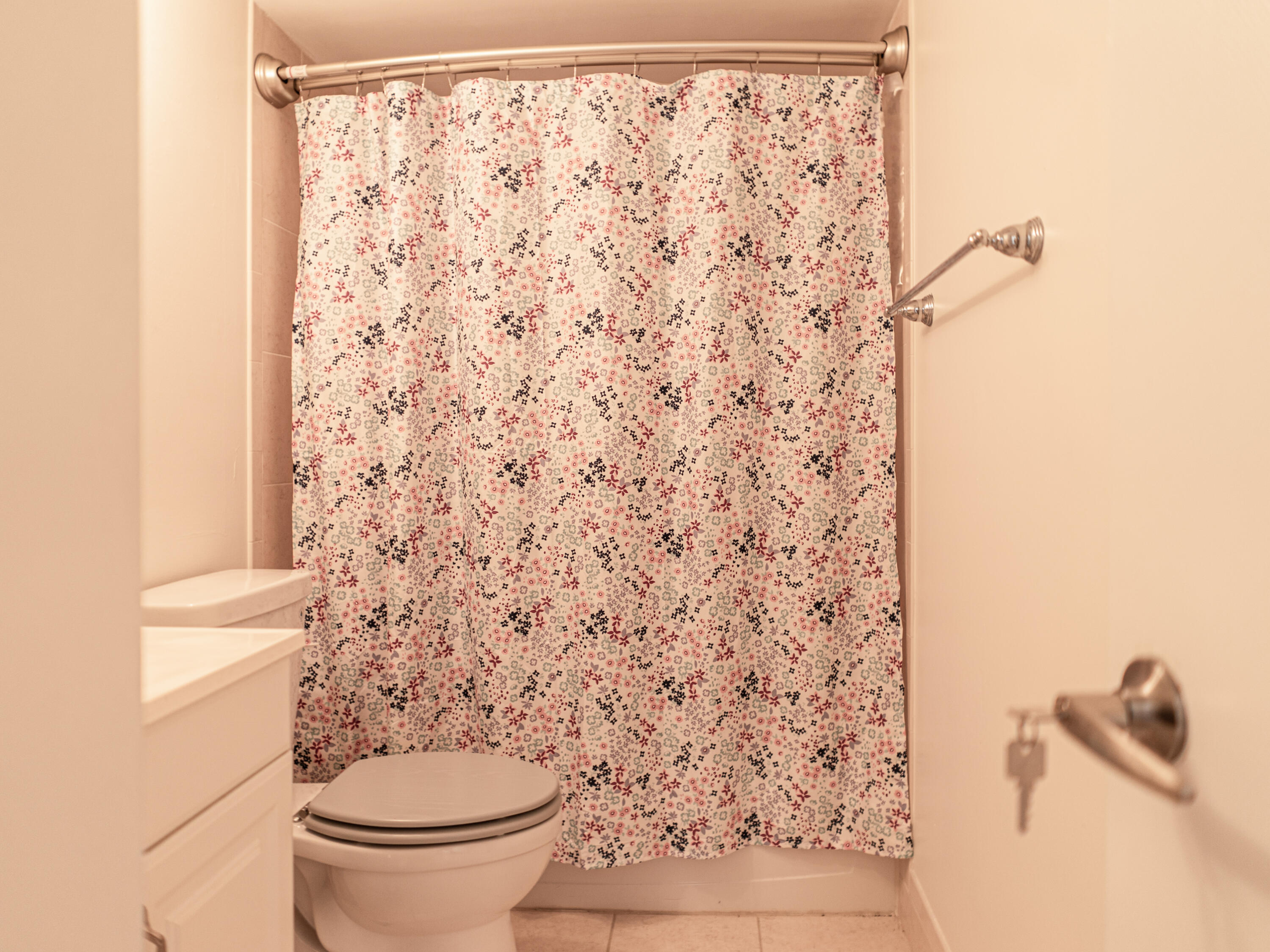 3118 Spanish Wells Drive, Unit 15B Delray Beach, FL 33445 - Photo 23 of 23 a bathroom with a toilet and a shower curtain