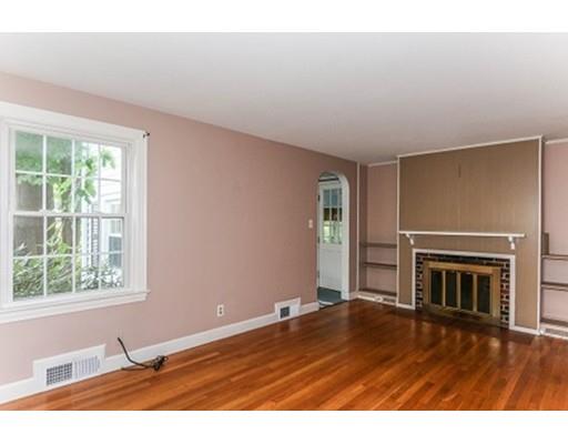 480 Plumtree Road Springfield, MA 01118 - Photo 11 of 28 an empty room with wooden floor fireplace and windows