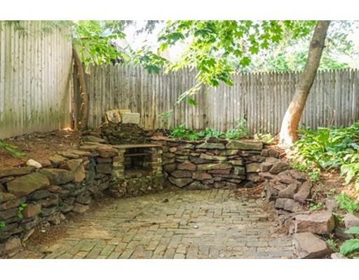 480 Plumtree Road Springfield, MA 01118 - Photo 26 of 28 a view of a backyard with large trees and wooden fence