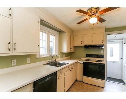 480 Plumtree Road Springfield, MA 01118 - Photo 5 of 28 a kitchen with a sink a stove cabinets and a window