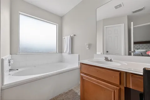 a bathroom with a bathtub and a sink