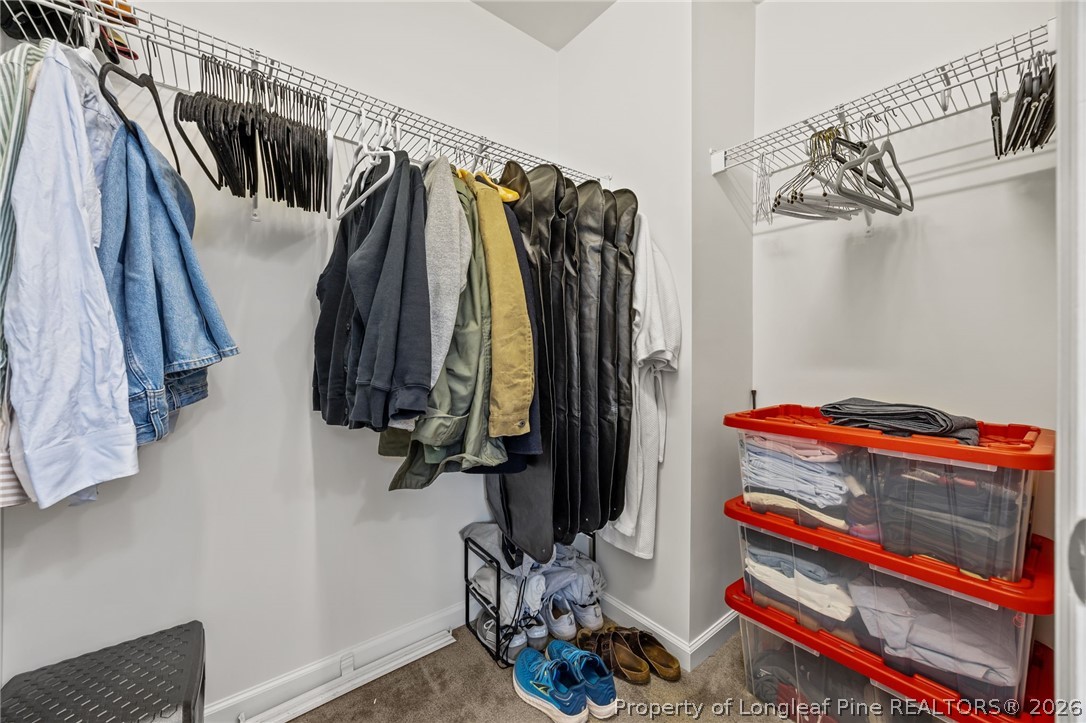 226 River Oak Street Spring Lake, NC 28390 - Photo 26 of 41 a view of walk in closet with clothes and shoes