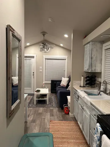 a kitchen with a sink appliances and cabinets
