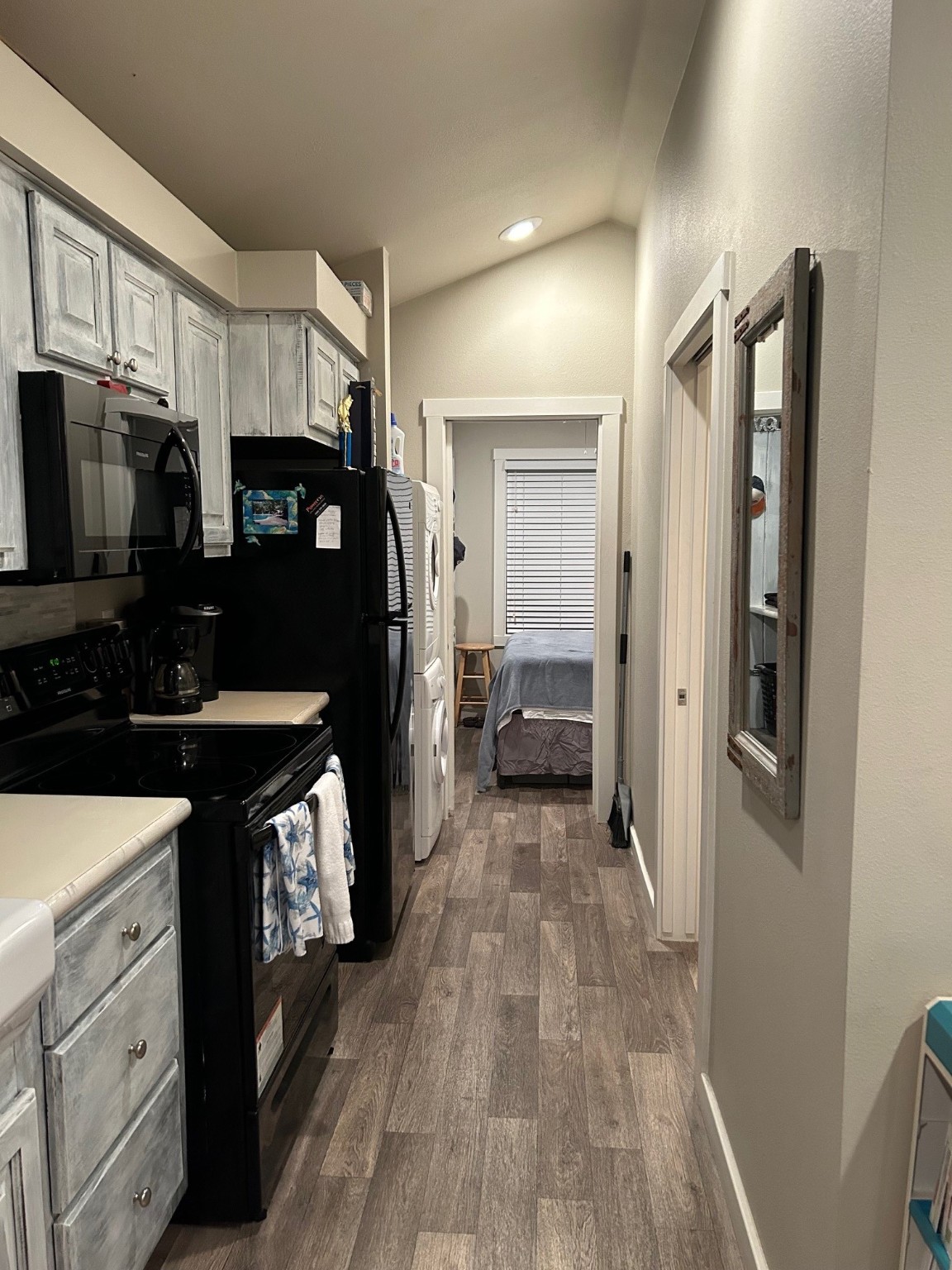 12922 Longstreet Road, Unit L10 Willis, TX 77318 - Photo 16 of 21 a kitchen with granite countertop a refrigerator and a sink