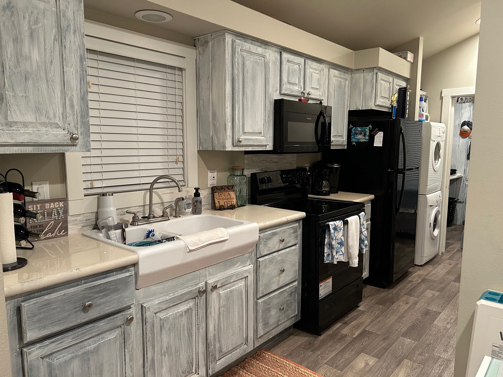 12922 Longstreet Road, Unit L10 Willis, TX 77318 - Photo 17 of 21 a kitchen with a sink appliances and cabinets