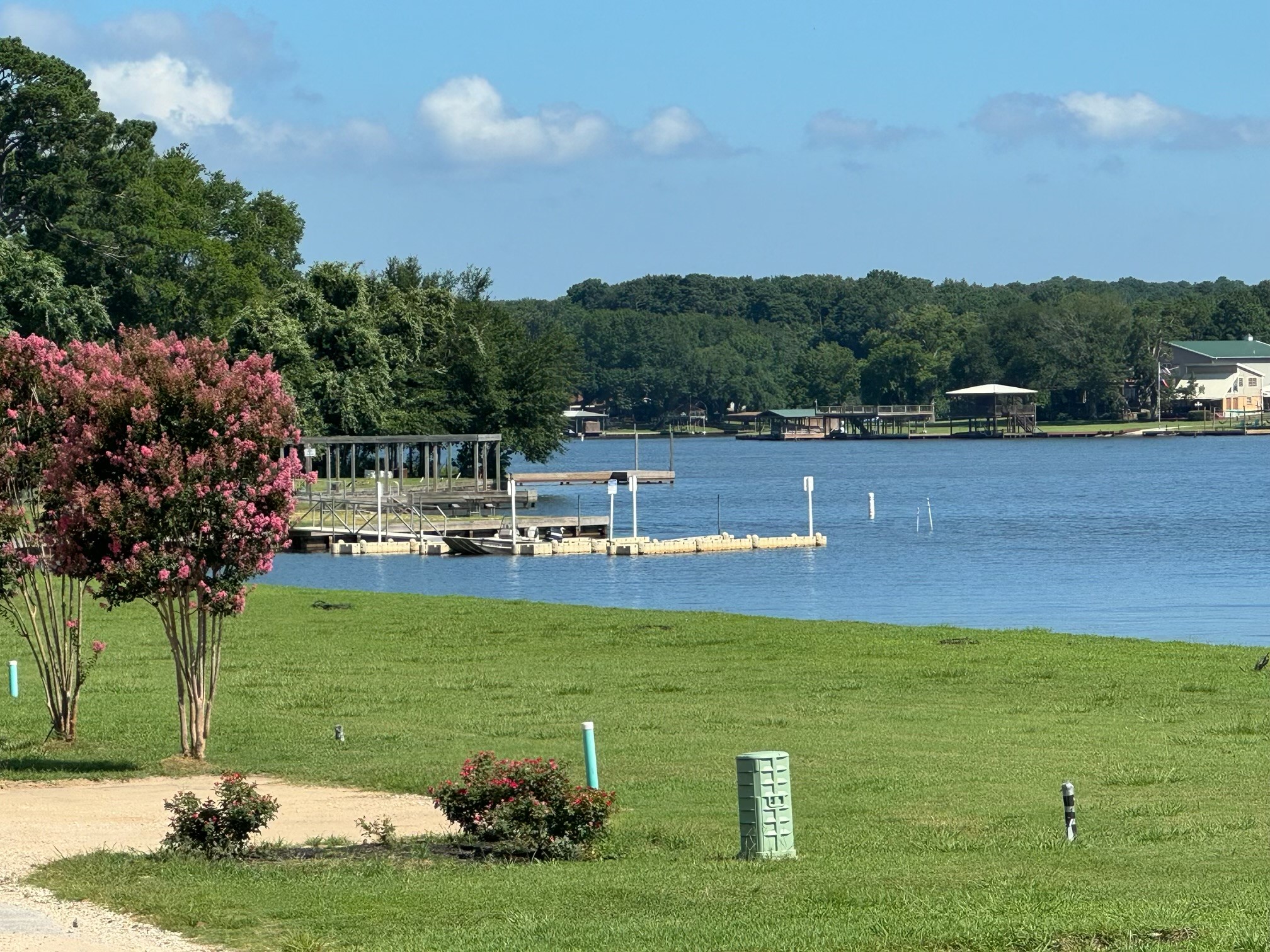 12922 Longstreet Road, Unit L10 Willis, TX 77318 - Photo 21 of 21 a view of a lake with a building in the background