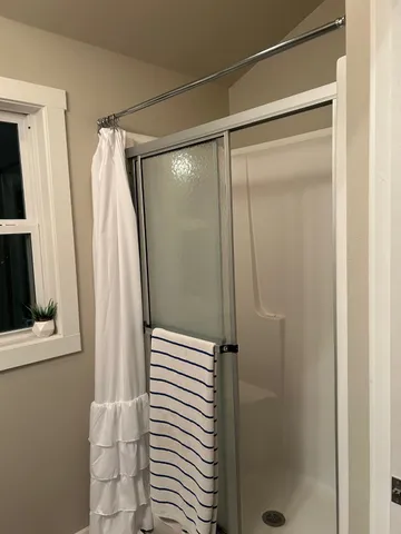 a bathroom with a glass shower door