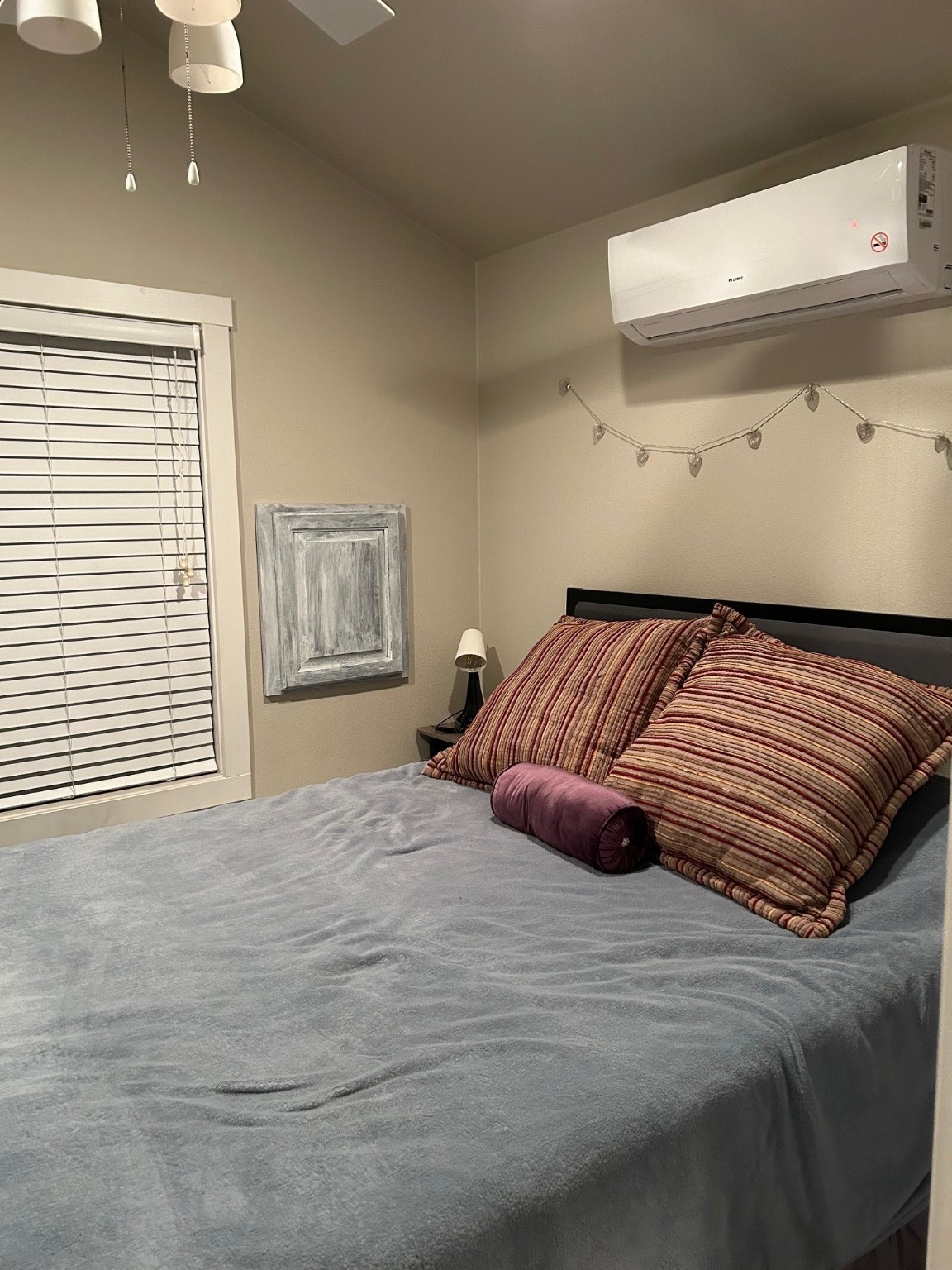 12922 Longstreet Road, Unit L10 Willis, TX 77318 - Photo 7 of 21 a bedroom with a bed and painting on the wall