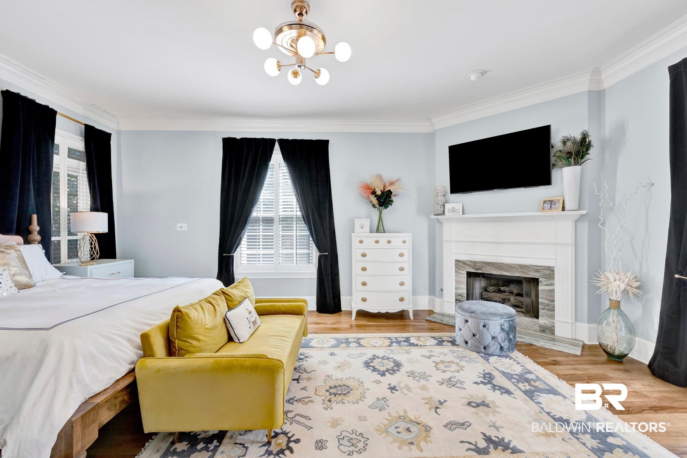 4 Savannah Court Mobile, AL 36608 - Photo 16 of 32 Bedroom with ornamental molding, wood finished floors, a chandelier, and a premium fireplace