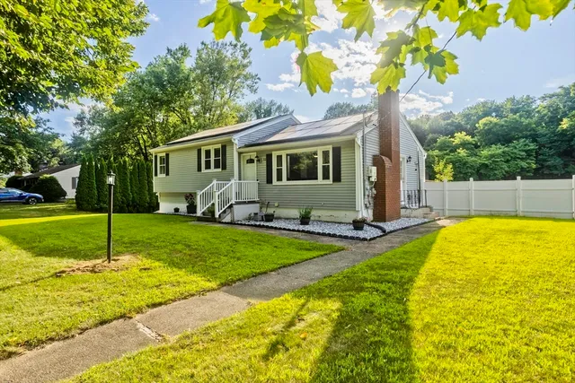 a view of a house with swimming pool and a yard
