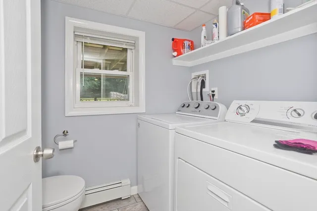 a bathroom with a sink toilet and a window