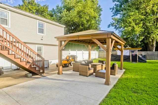 a view of a house with backyard and porch