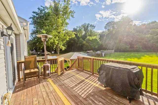 a view of balcony with wooden floor and outdoor seating