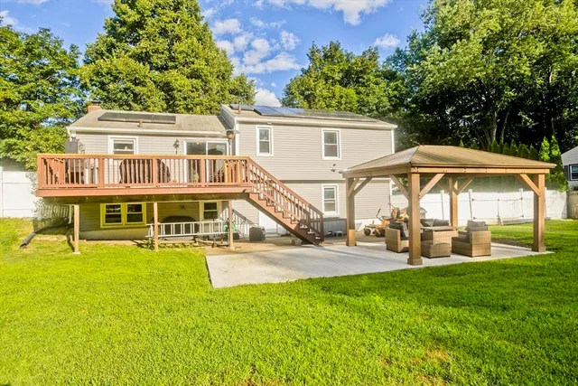 a view of a house with backyard porch and sitting area