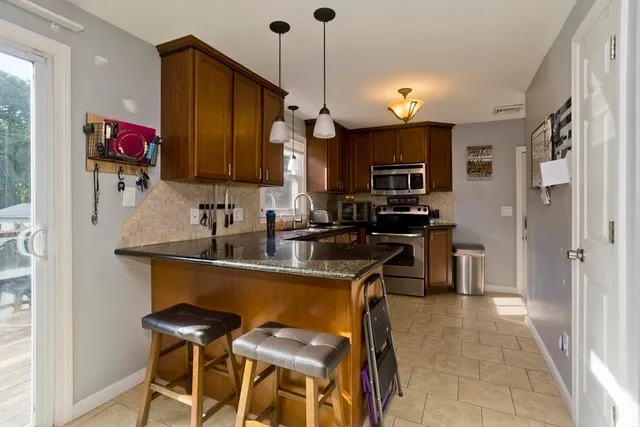 a kitchen with a sink cabinets and refrigerator