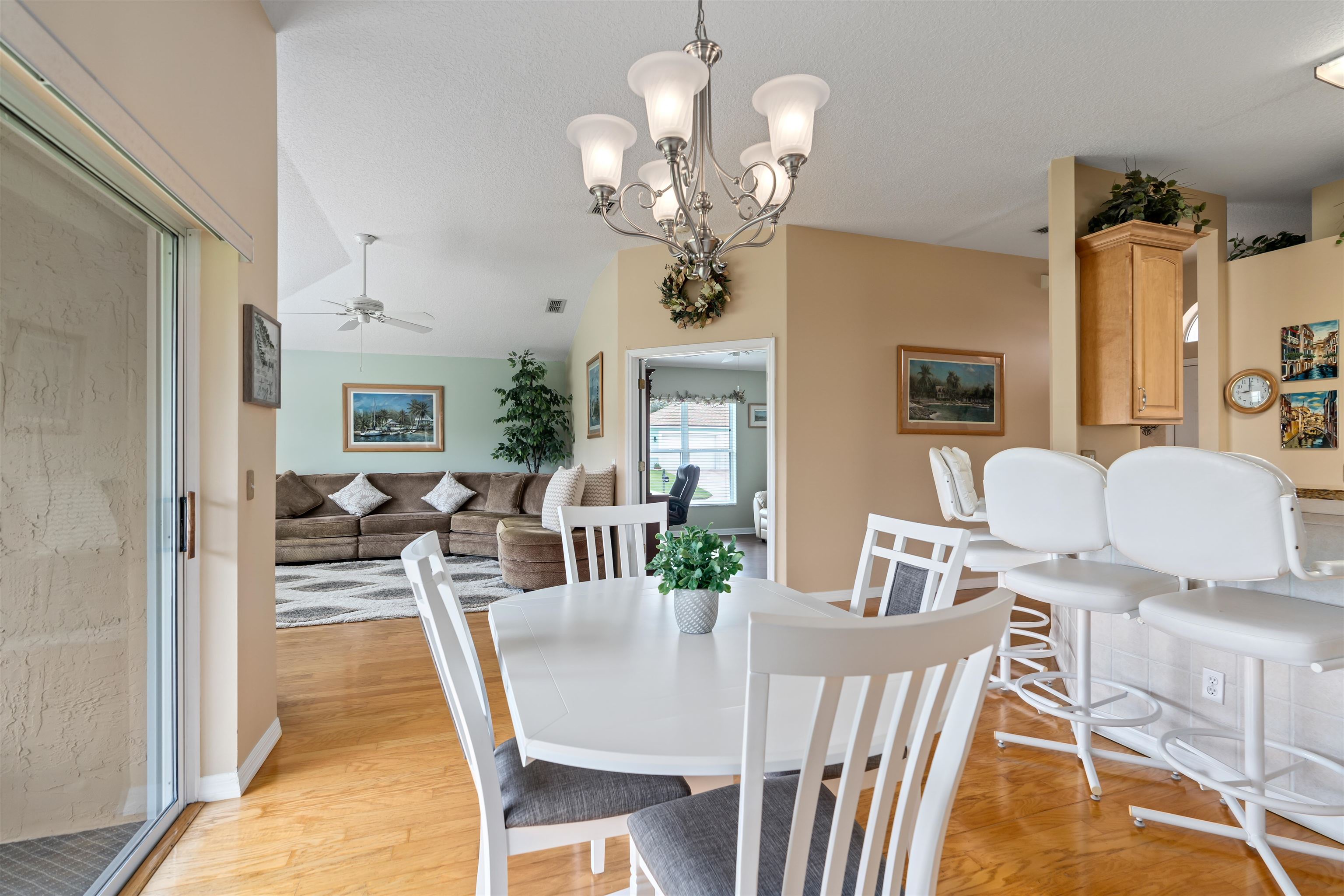 2325 Commodores Club Boulevard St. Augustine, FL 32080 - Photo 11 of 38 a view of a dining room with furniture a chandelier and wooden floor