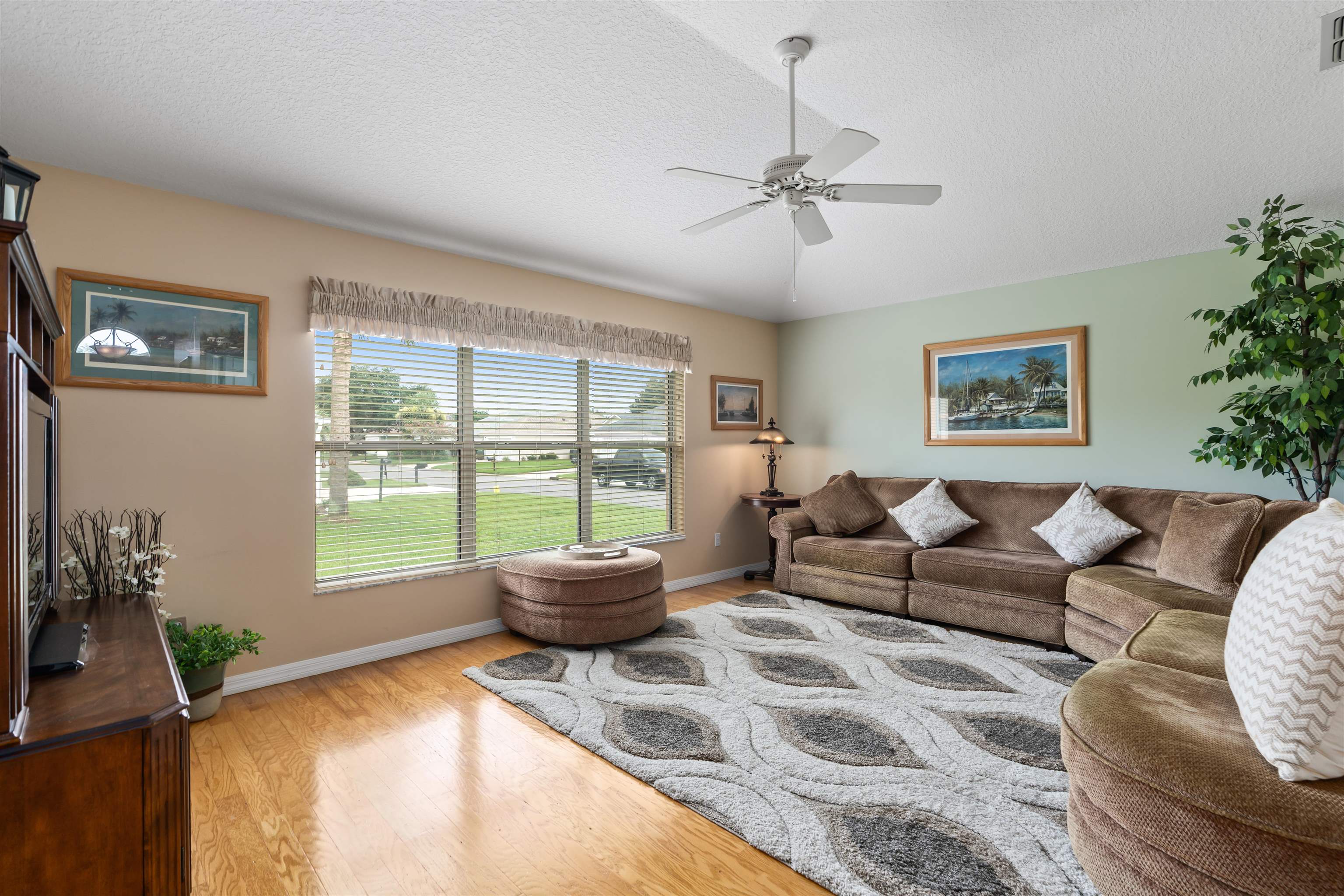 2325 Commodores Club Boulevard St. Augustine, FL 32080 - Photo 12 of 38 a living room with furniture floor to ceiling window and a potted plant