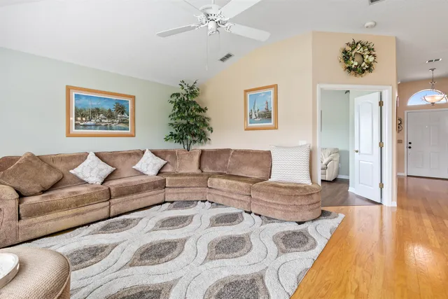 a living room with furniture and a wooden floor