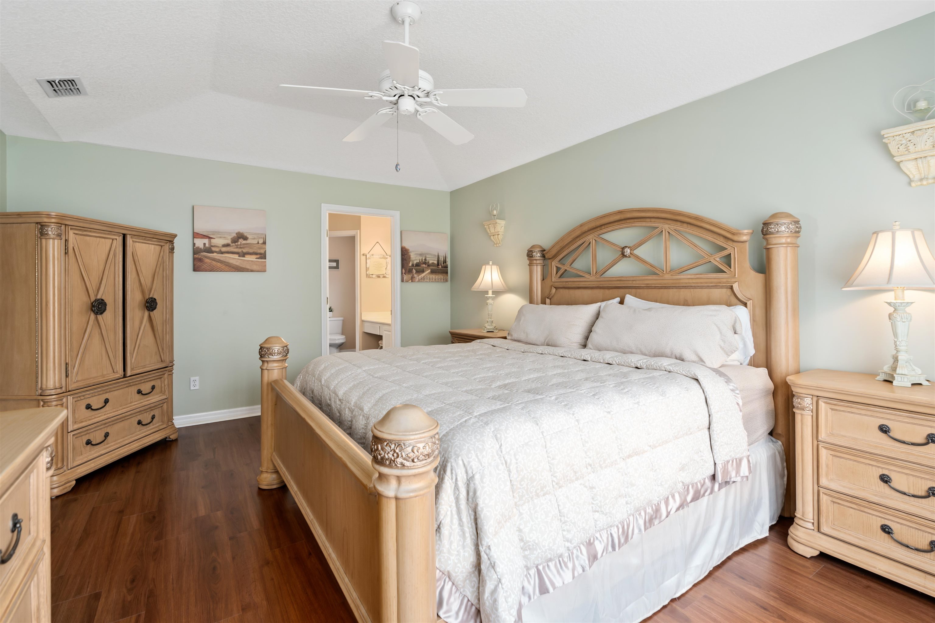 2325 Commodores Club Boulevard St. Augustine, FL 32080 - Photo 23 of 38 a bedroom with a bed a dresser with wooden floor