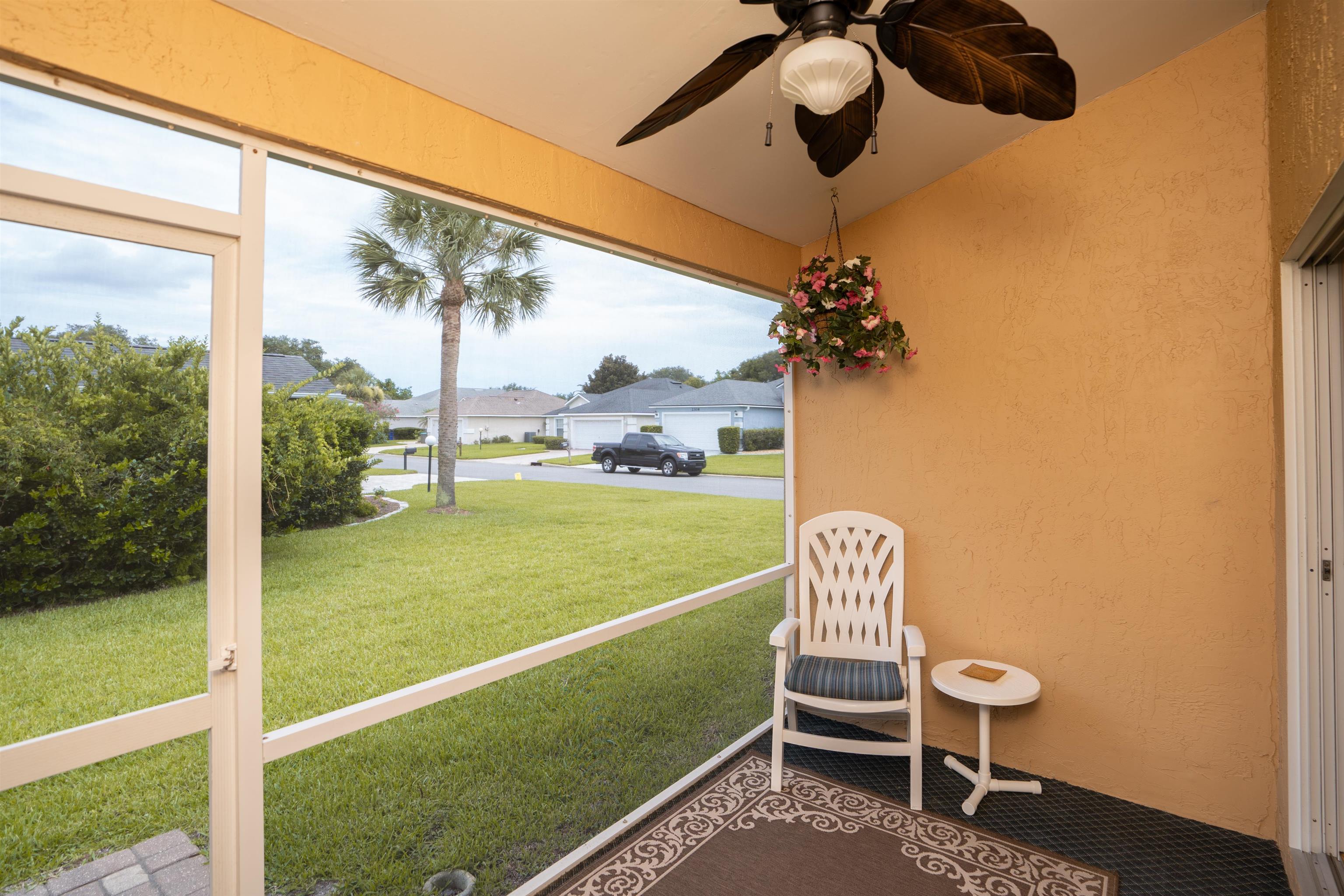 2325 Commodores Club Boulevard St. Augustine, FL 32080 - Photo 27 of 38 a view of a porch with furniture and a yard