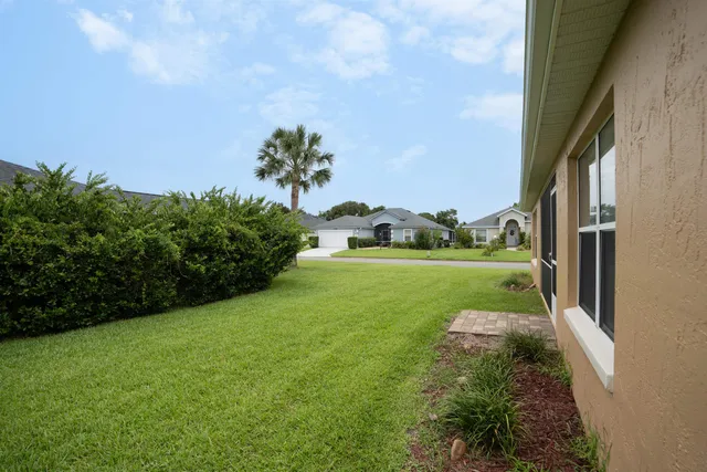 a view of a garden with a building in the background