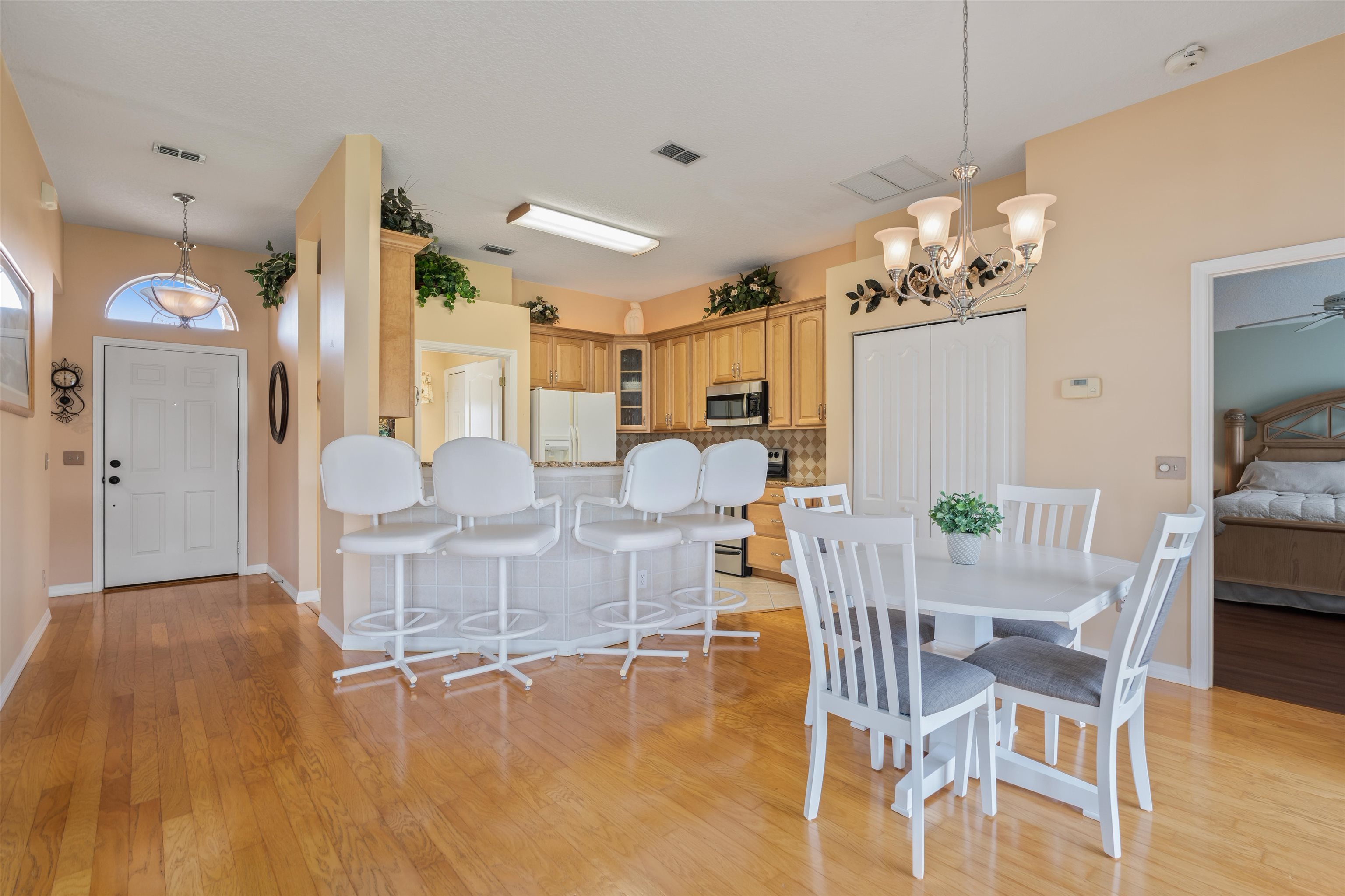 2325 Commodores Club Boulevard St. Augustine, FL 32080 - Photo 5 of 38 a view of a dining room with furniture and chandelier