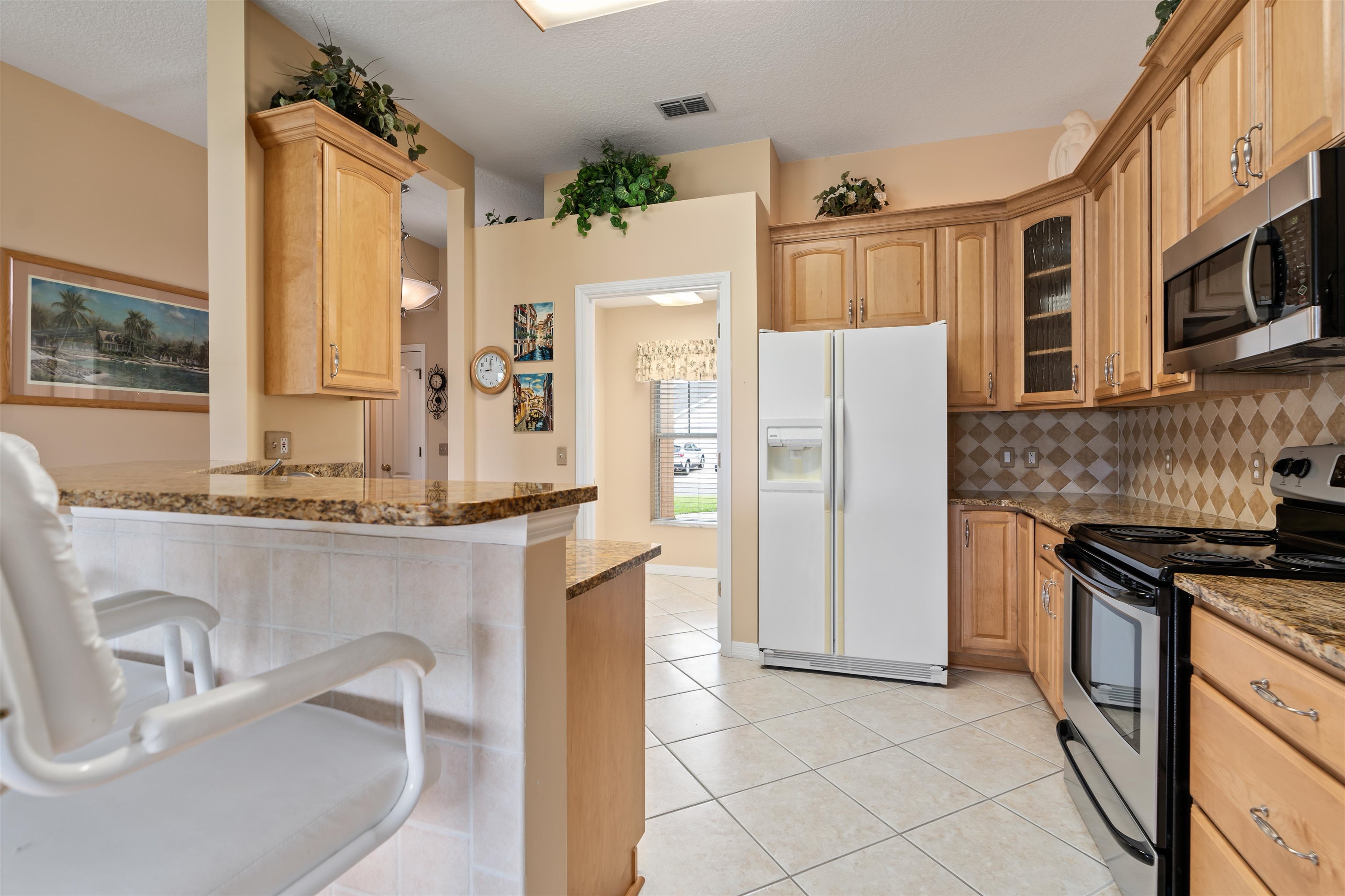 2325 Commodores Club Boulevard St. Augustine, FL 32080 - Photo 6 of 38 a kitchen with stainless steel appliances granite countertop a sink stove and refrigerator