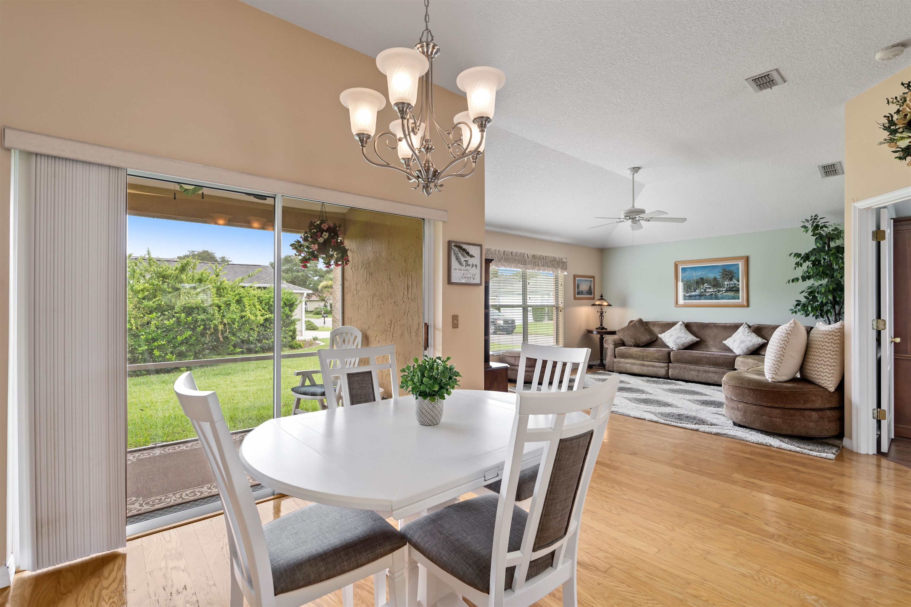 2325 Commodores Club Boulevard St. Augustine, FL 32080 - Photo 10 of 38 a view of a dining room with furniture a chandelier and wooden floor