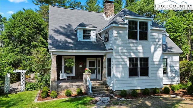 a front view of a house with garden and porch