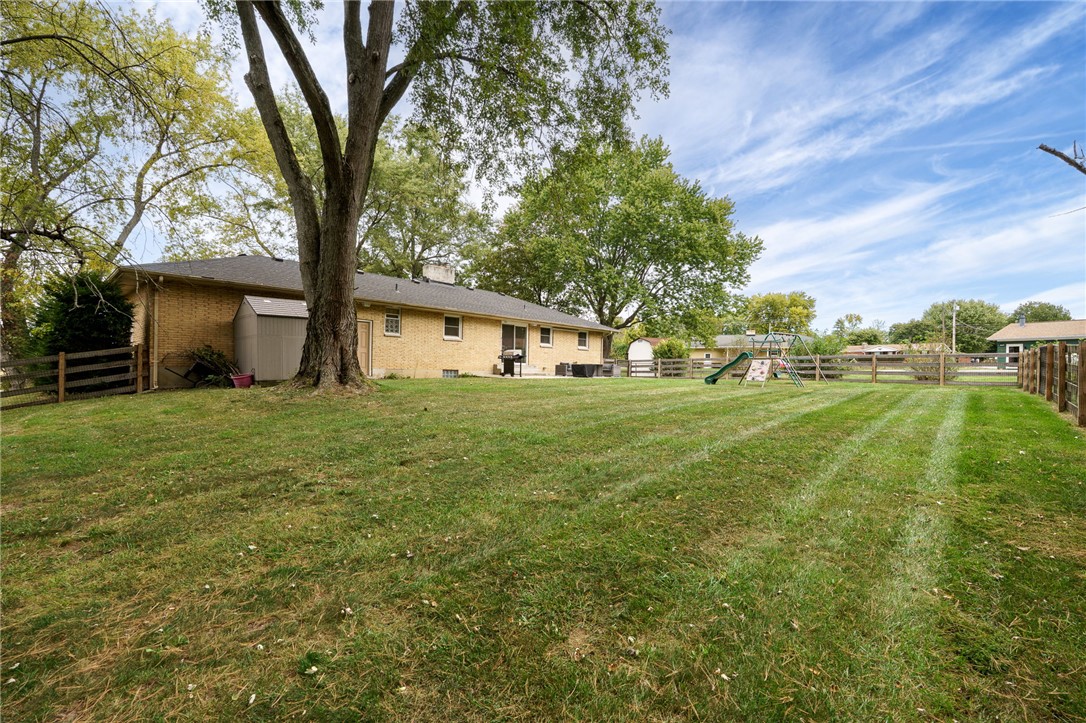 6950 Red Lion 5 Points Road Springboro, OH 45066 - Photo 58 of 78 This spacious backyard offers ample room for relaxation and recreation, featuring a well-maintained lawn and sturdy fencing.