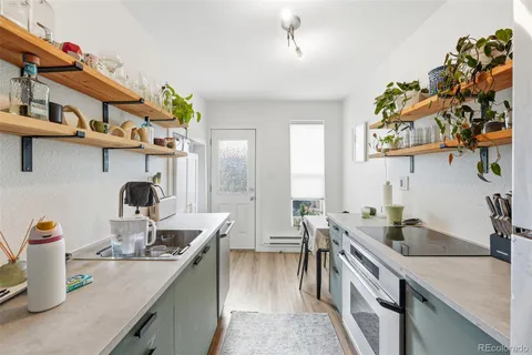 a kitchen with stainless steel appliances granite countertop a sink and a stove