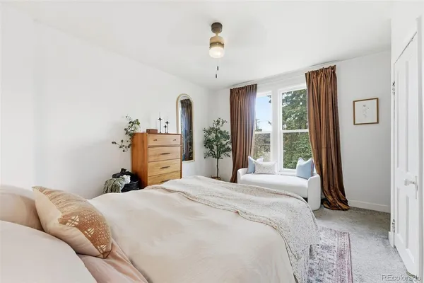 a bedroom with a large bed and a chandelier