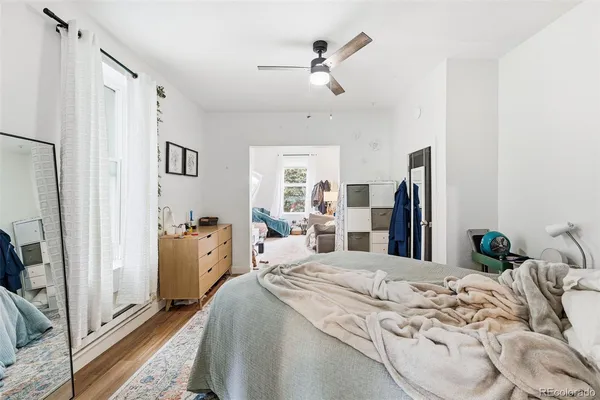 a bed room with a bed and a flat tv screen