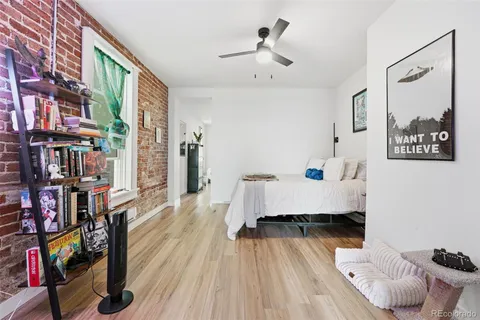 a living room with furniture and a book shelf