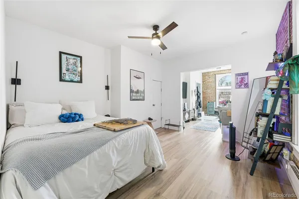 a bedroom with bed and a wooden floor