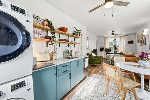 a very nice looking kitchen with granite countertop a sink a stove and cabinets