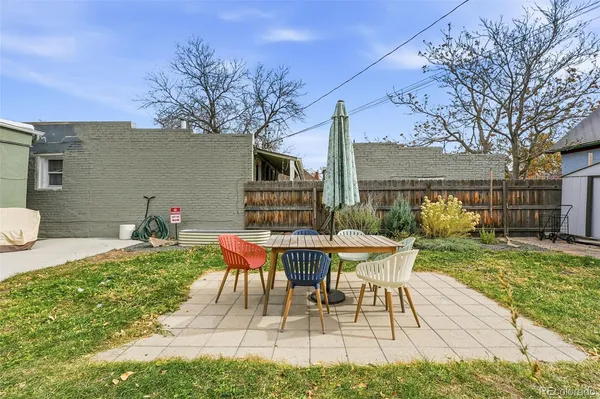 a view of a house with backyard sitting area and garden