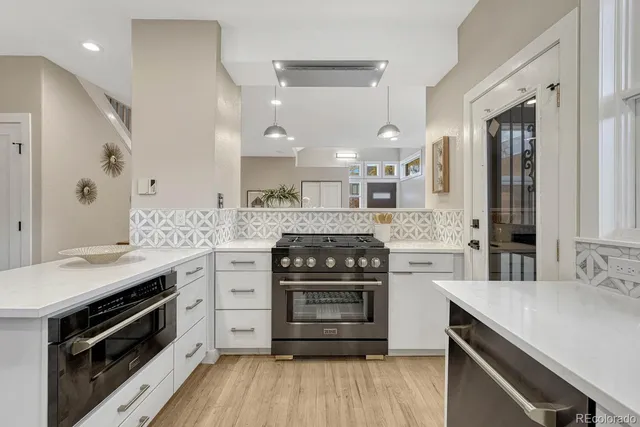 a kitchen with a stove and cabinets