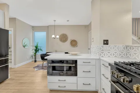 a kitchen with a refrigerator and a sink