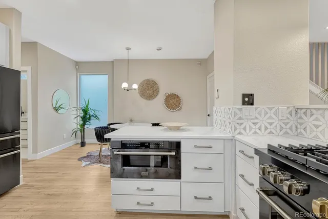 a kitchen with a refrigerator and a sink