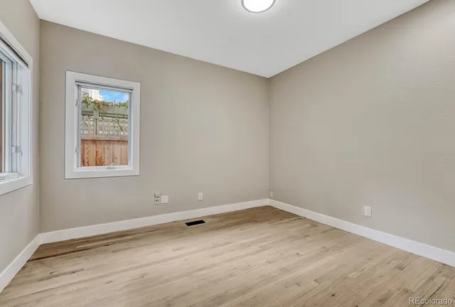 wooden floor in an empty room with wooden door