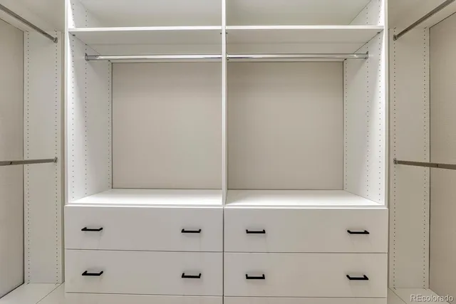 a bathroom with a granite countertop sink a mirror and shower