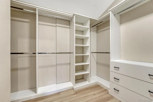 a bathroom with a tub a sink and mirror
